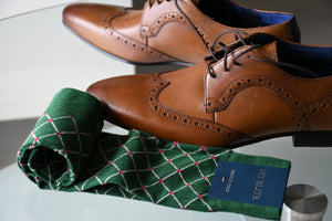 Men's fashion socks, green with red polka dots, coupled with brown derby shoes