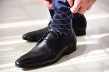 Blue dress socks for men with a colorful design matching black derby shoes