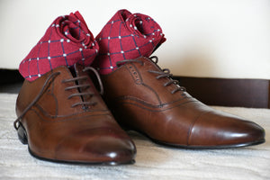 Colorful red socks for men with grey polka dots and brown oxford shoes