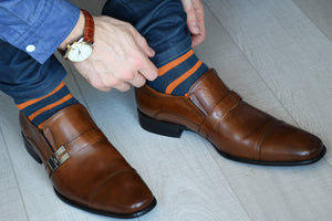 Cool socks for men, navy blue with orange stripes matching brown dress shoes and jeans