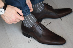 Grey socks for men with vertical stripes matching casual outfit