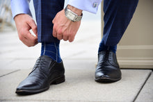 Men's blue checkered dress socks with a matching corporate look
