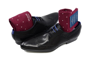 Men's burgundy dress socks with grey polka dots and black shoes