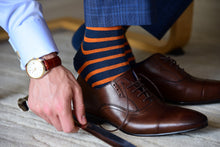 Men's colorful dress socks matching gold watch and navy suit