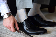 Elegant dress socks for men, light grey with blue checks, matching formal outfit