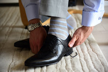Men's grey dress socks with light blue stripes matching grey suit and blue cufflinks