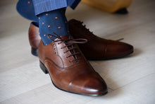 Men's stylish navy dress socks with orange polka dots matching brown oxford shoes