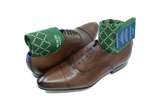 Men's colorful dress socks, green with red dots, inside brown shoes