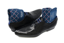 Men's patterned dress socks, navy blue with red polka dots design, inside black dress shoes