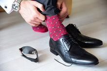 Business socks for men with grey polka dots matching accessories and black suit