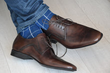 Stylish check patterned blue socks for men with matching blue jeans and brown shoes