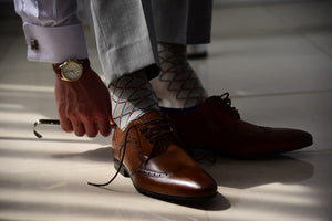 Stylish dress socks for men matching brown derby shoes and gold watch